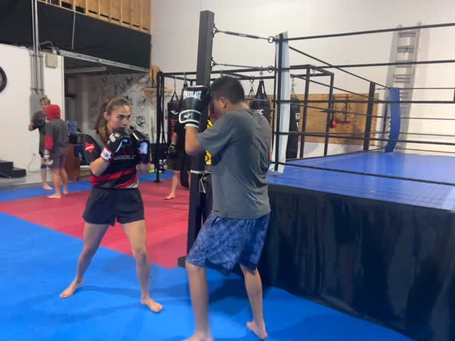 Kickboxing pad work with a coach at Tru Bloodline MMA & Fitness in Kemah, TX
