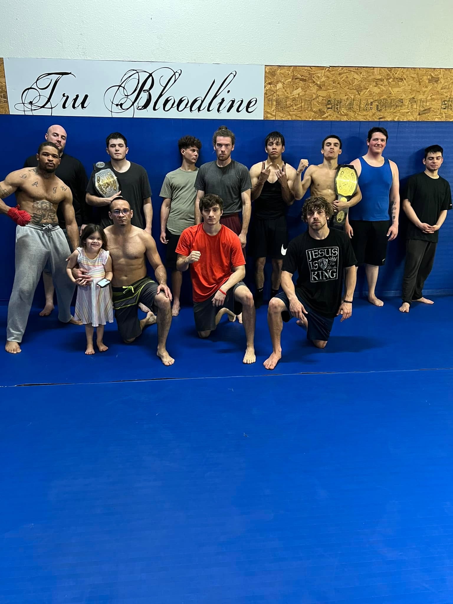Adult and kid members after class at Tru Bloodline MMA & Fitness